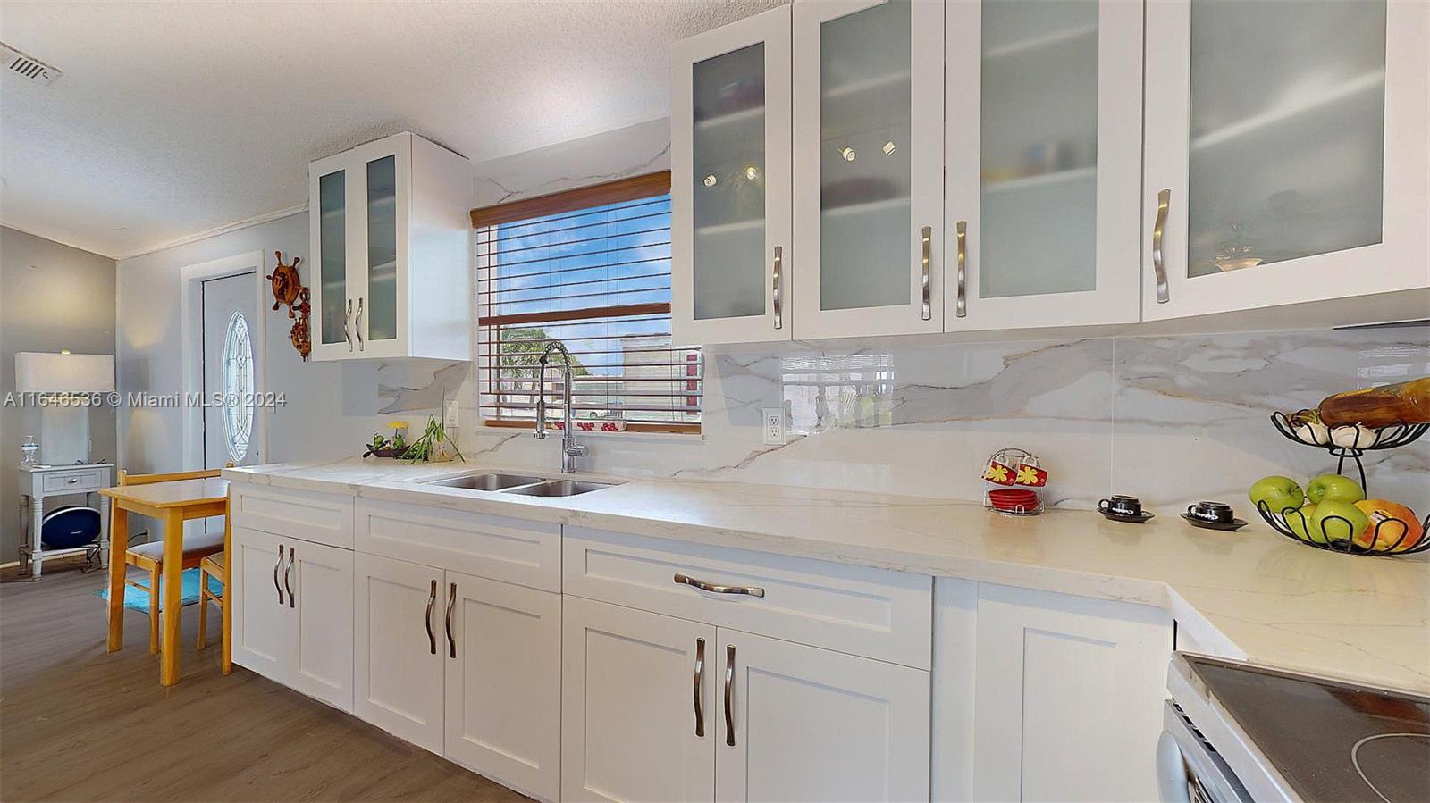 a kitchen with cabinets and window