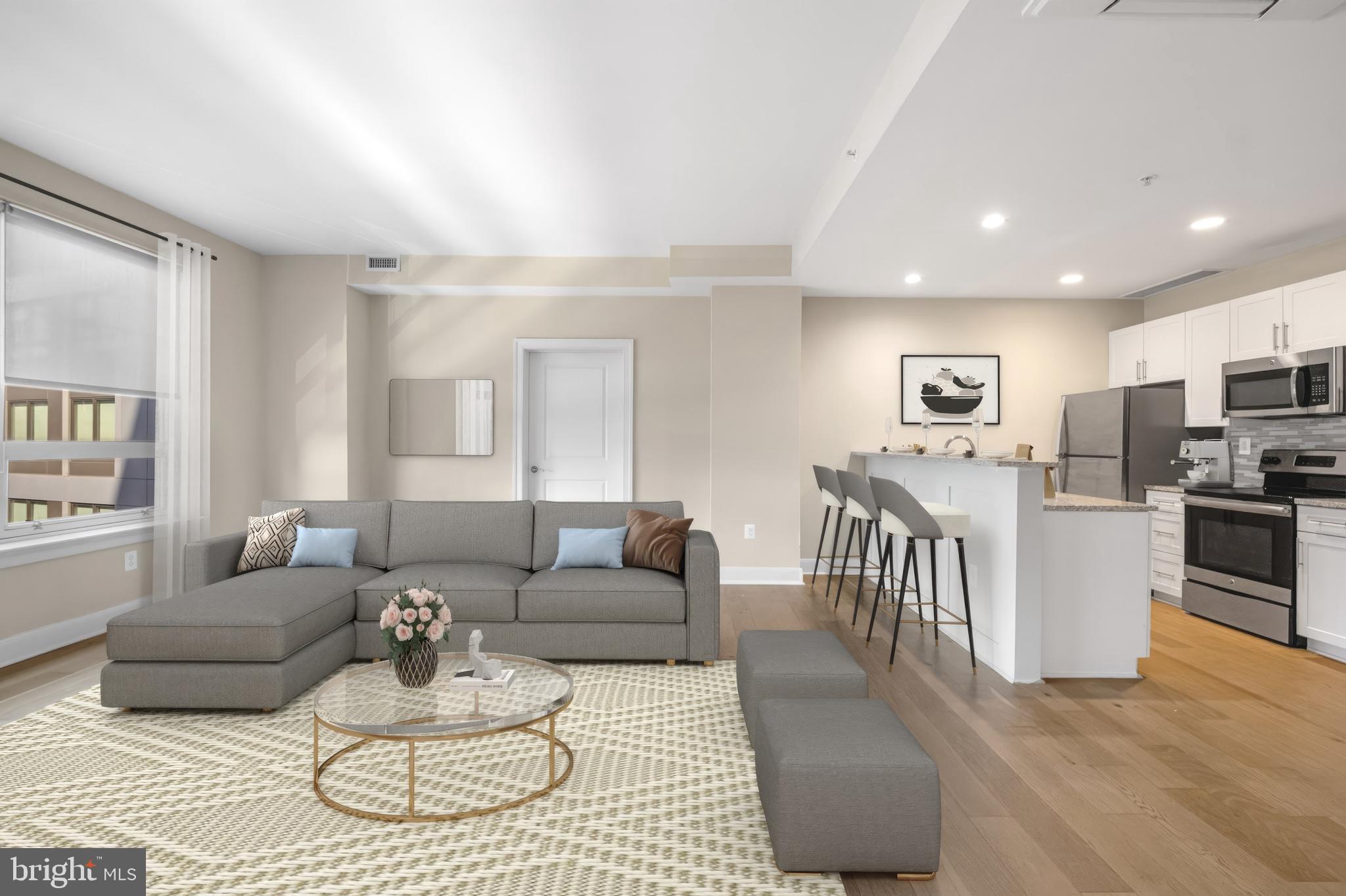 a living room with furniture and kitchen view