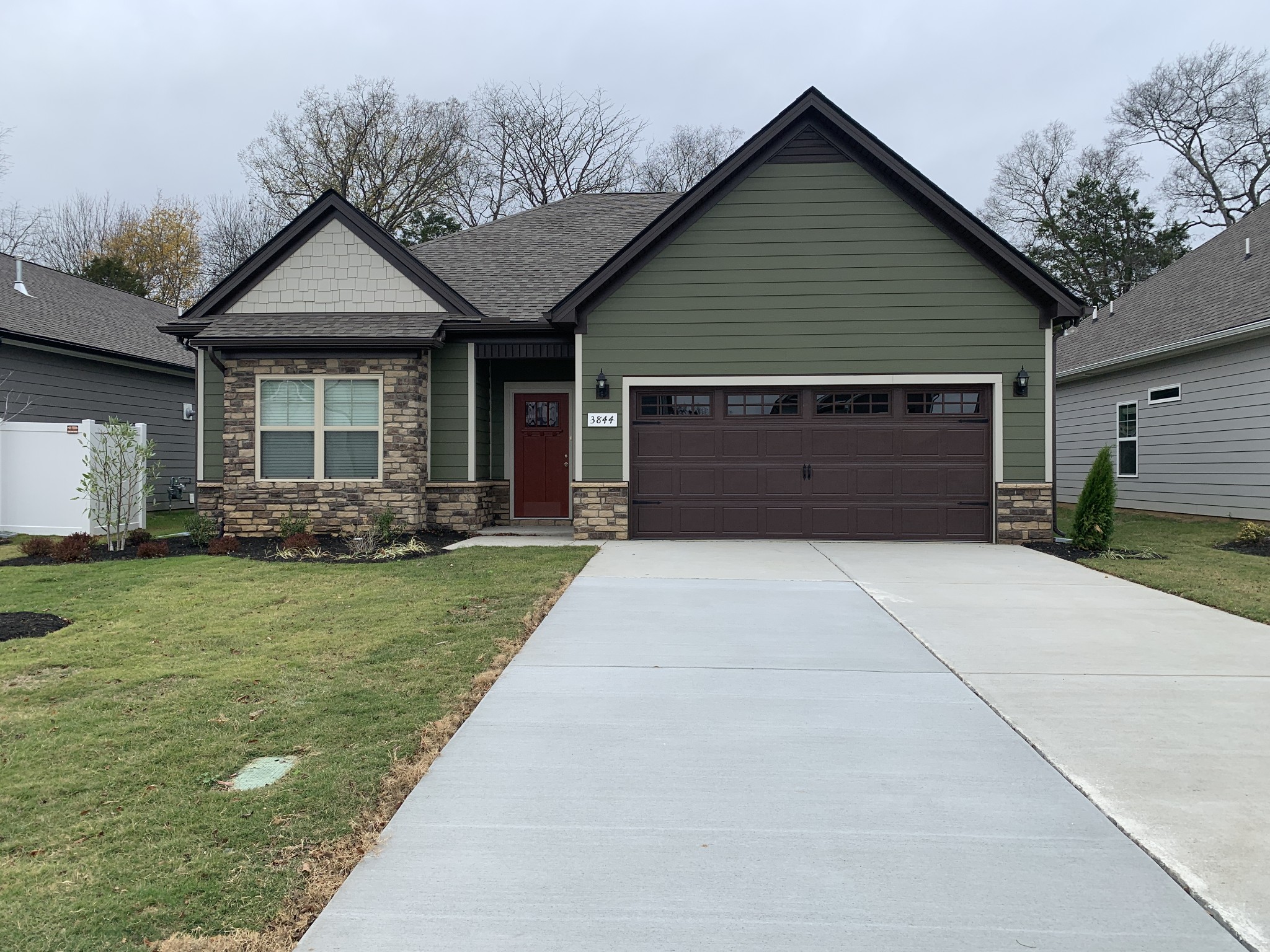 a front view of a house with a garden and yard