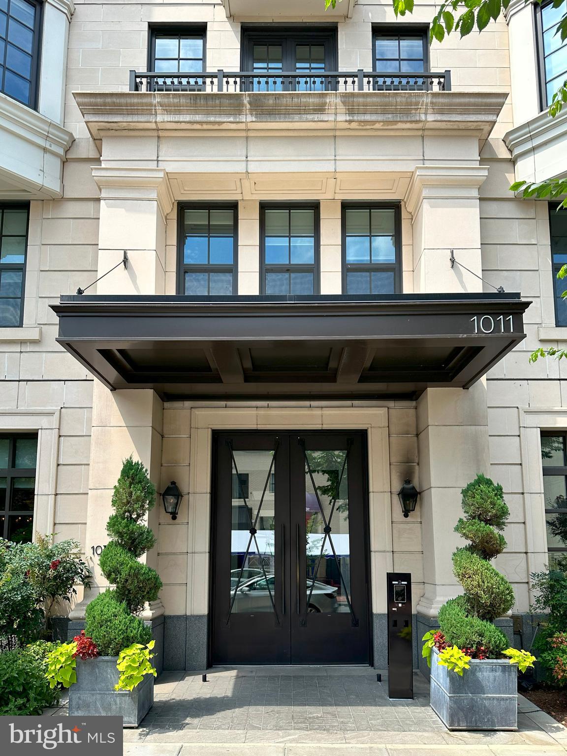 a front view of a building with potted plants