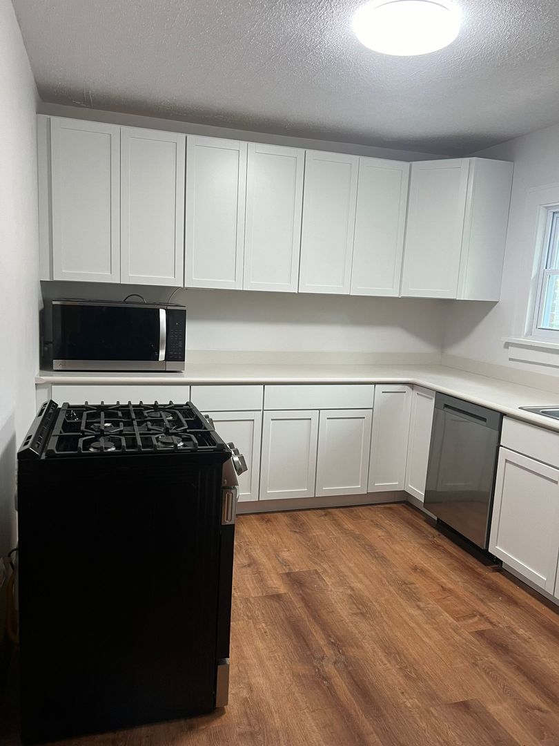 a kitchen with granite countertop a stove and a refrigerator