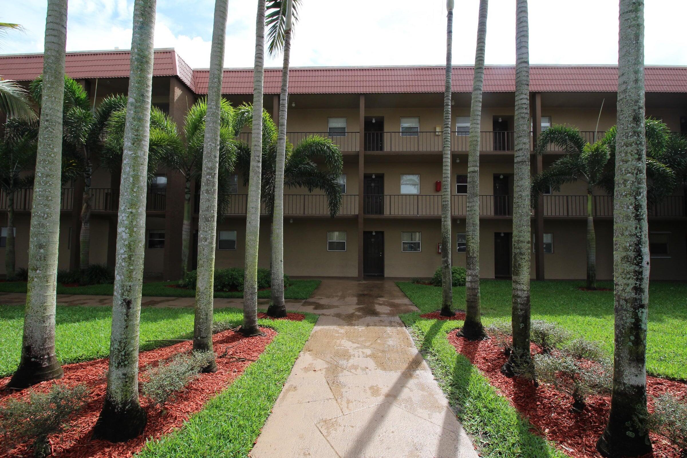 a front view of a building with a garden