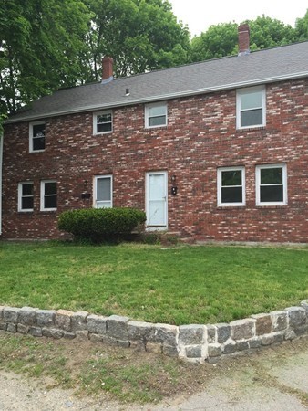 a view of house with a yard