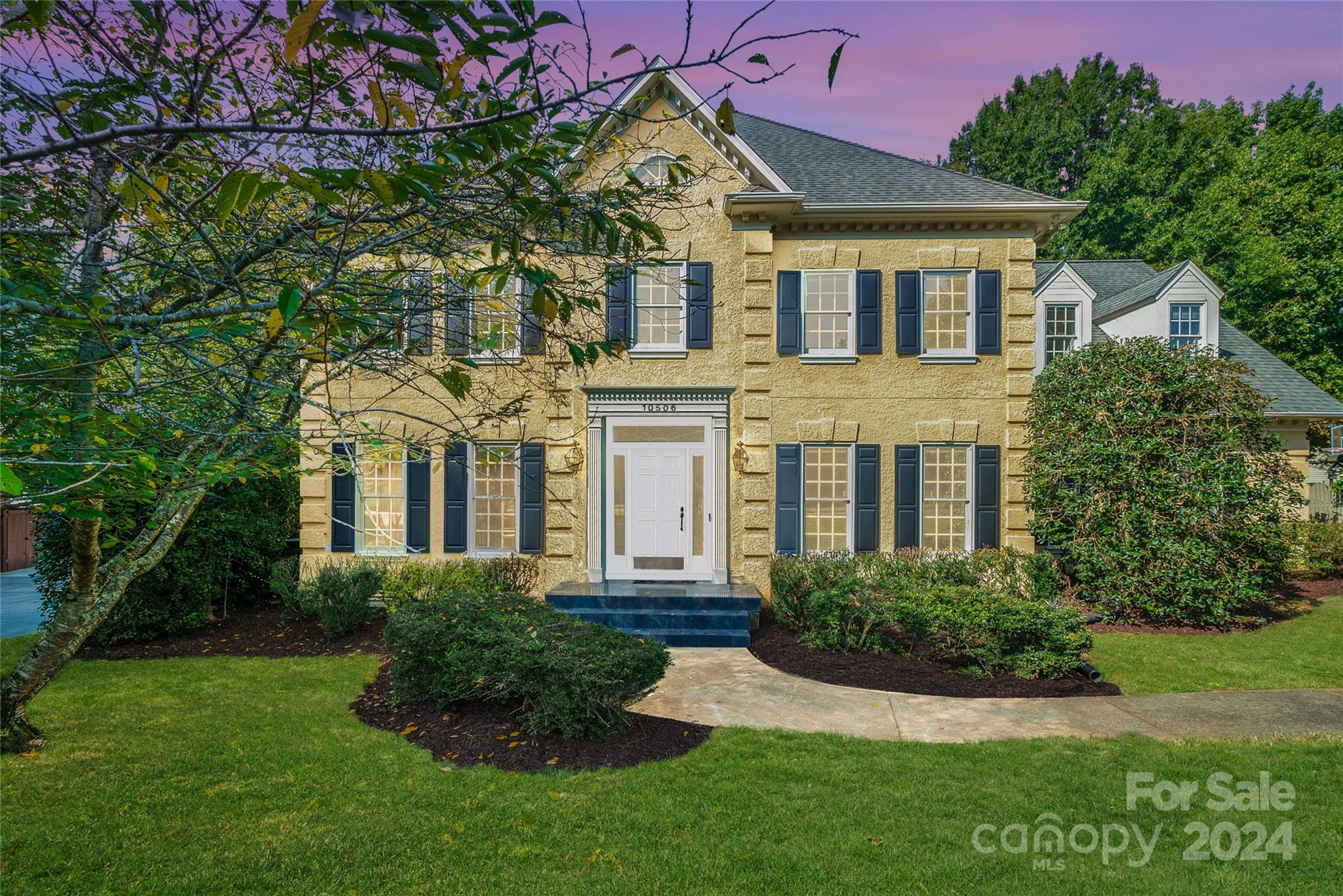 a front view of a house with a yard