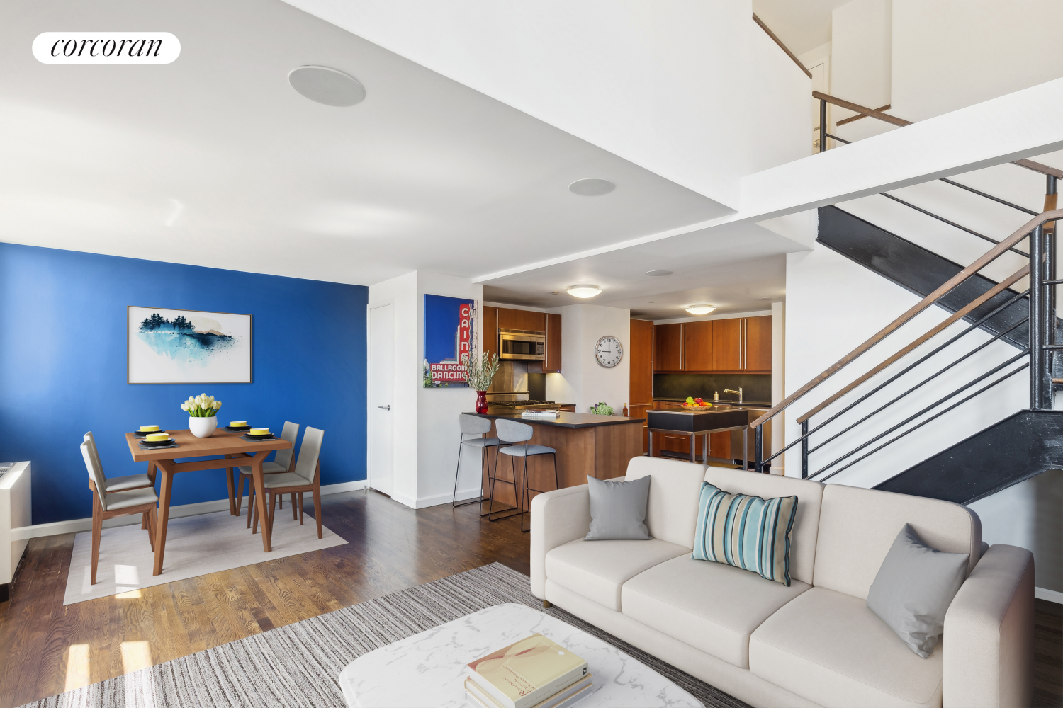 a living room with furniture and a wooden floor