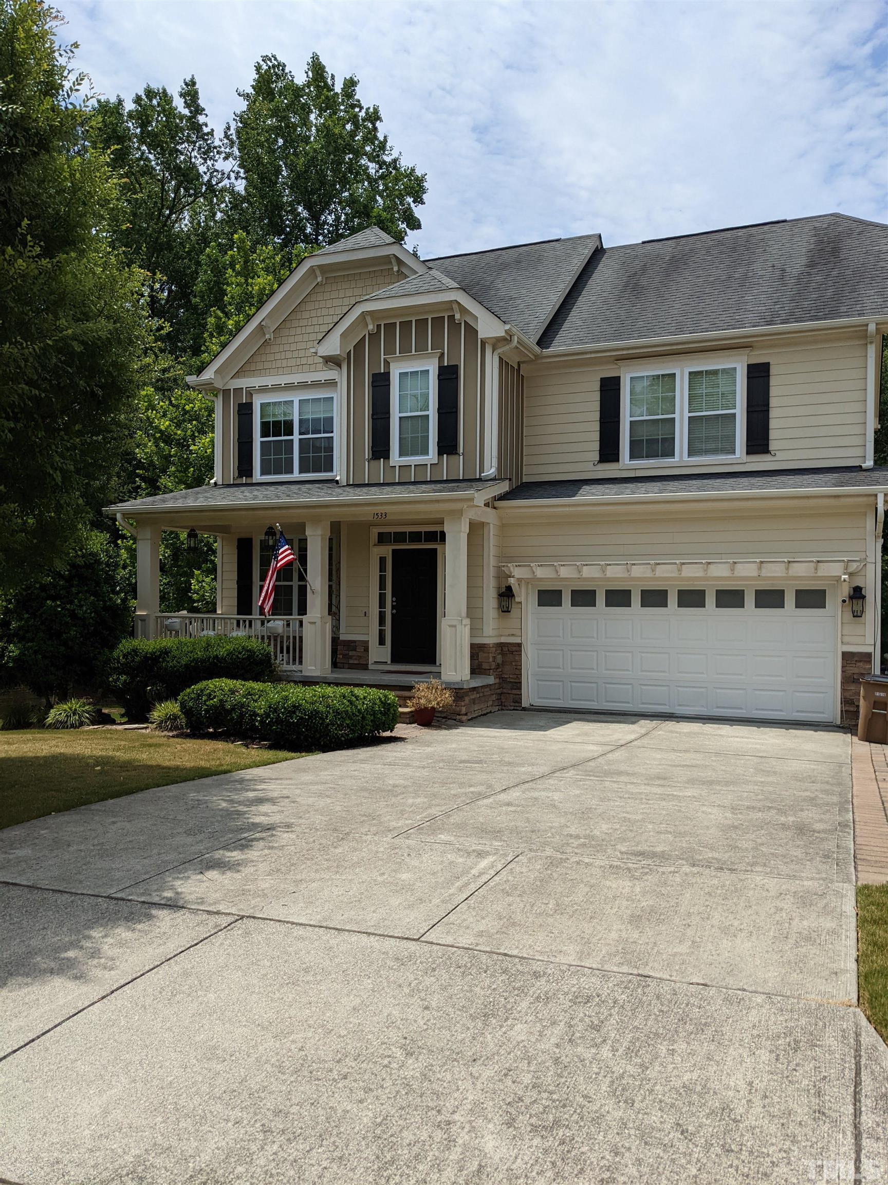 a front view of a house with a yard and garage