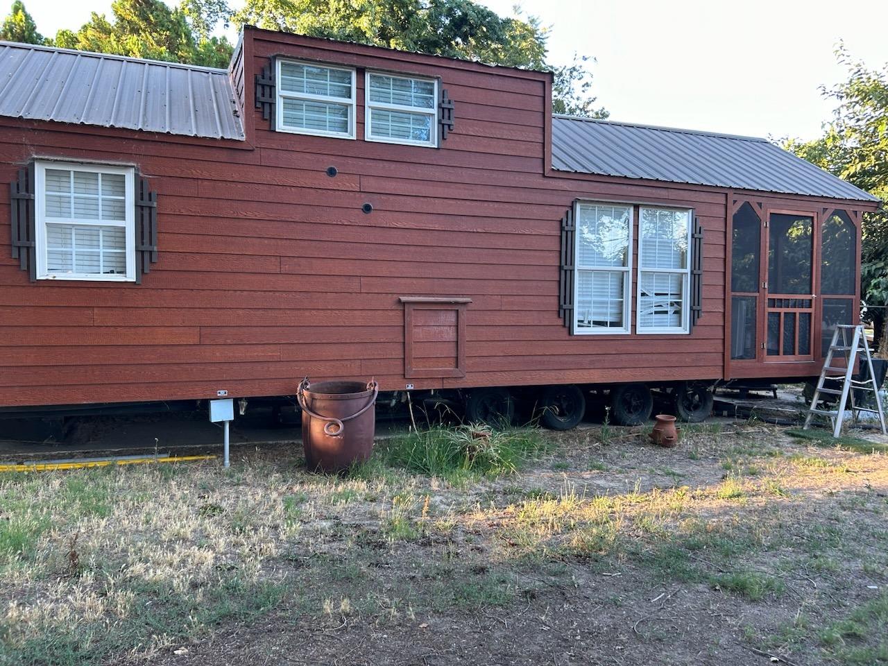 a backyard of a house with barbeque oven