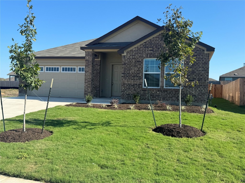 a view of a house with a backyard