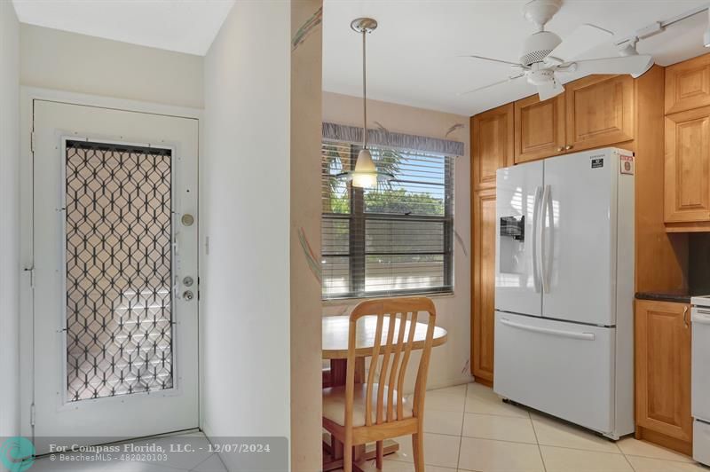 a kitchen with stainless steel appliances granite countertop a refrigerator and a window