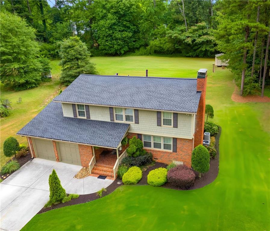 a aerial view of a house with swimming pool and a yard