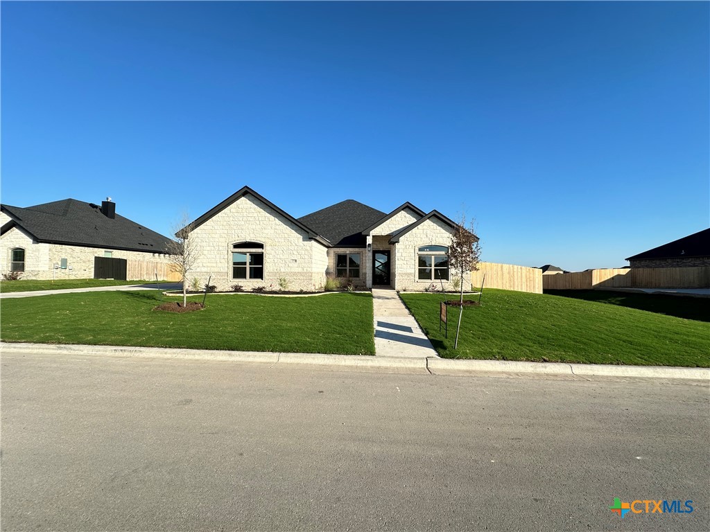 a front view of house with yard and green space