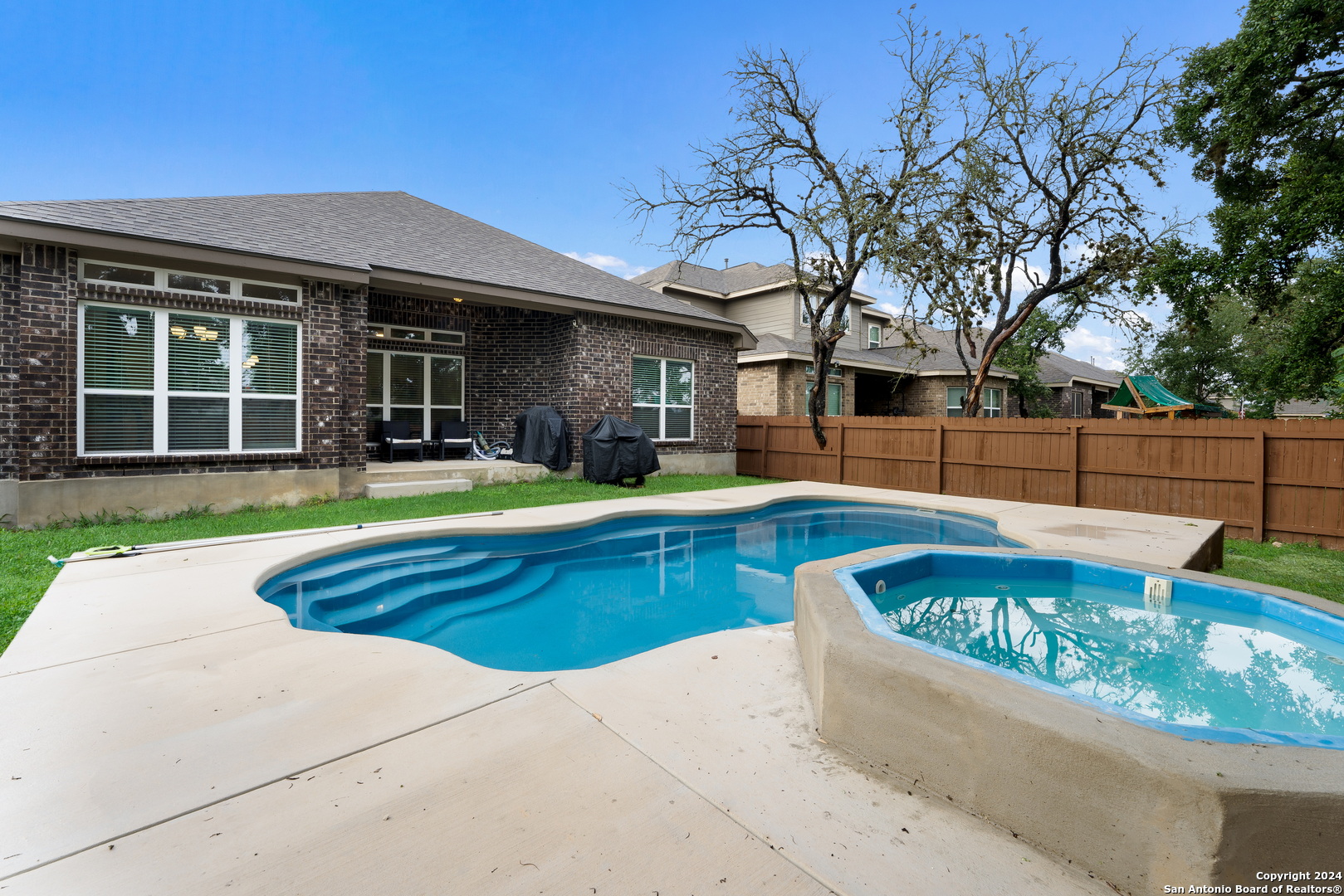 a view of a house with swimming pool and sitting area