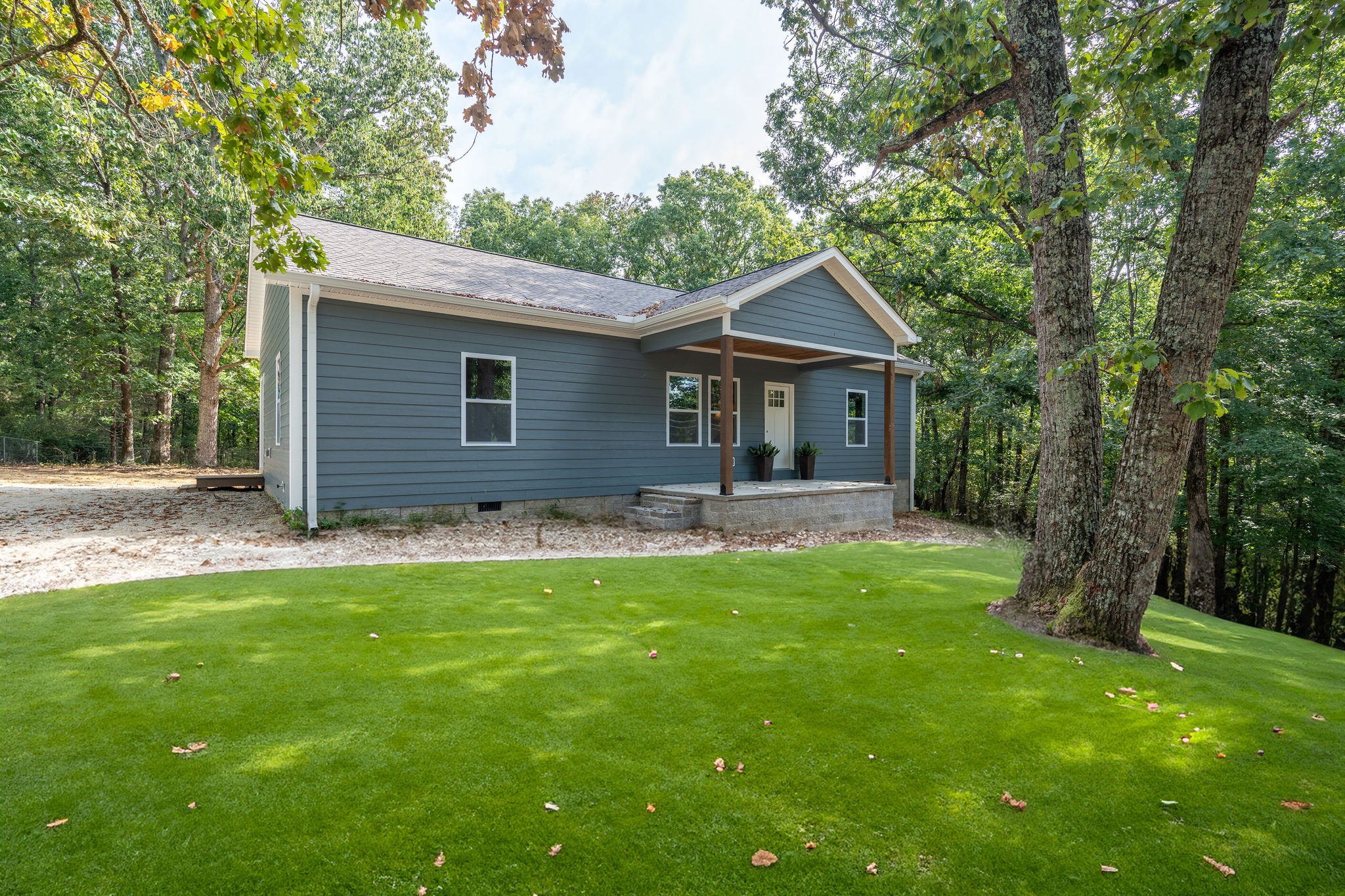 a front view of house with yard and green space