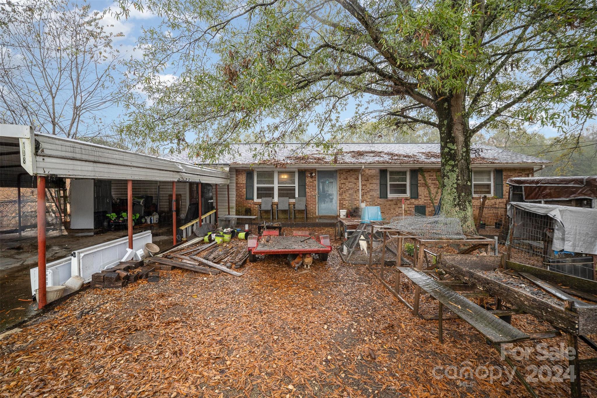 a view of a house with backyard porch and sitting area