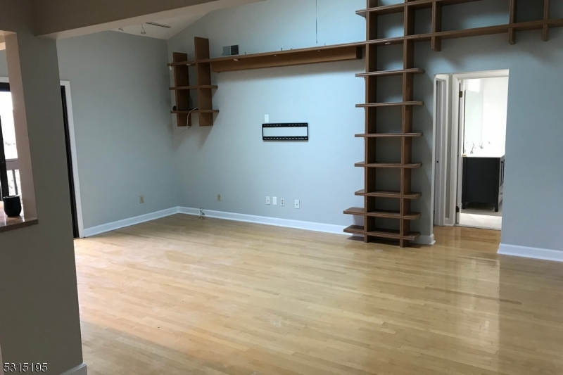 an empty room with shelves and windows