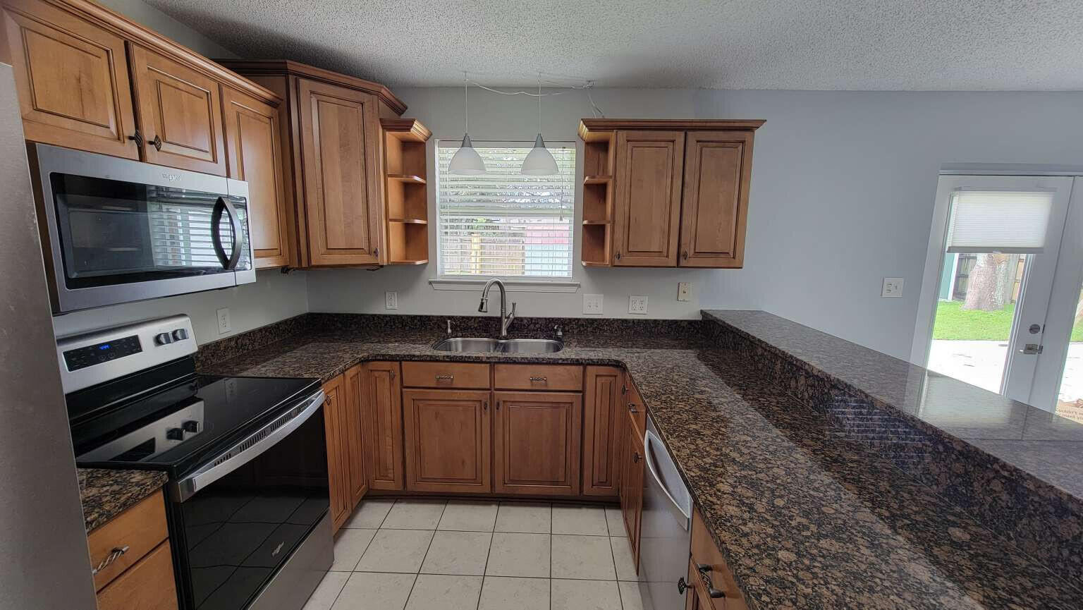 a kitchen with a sink stove and cabinets