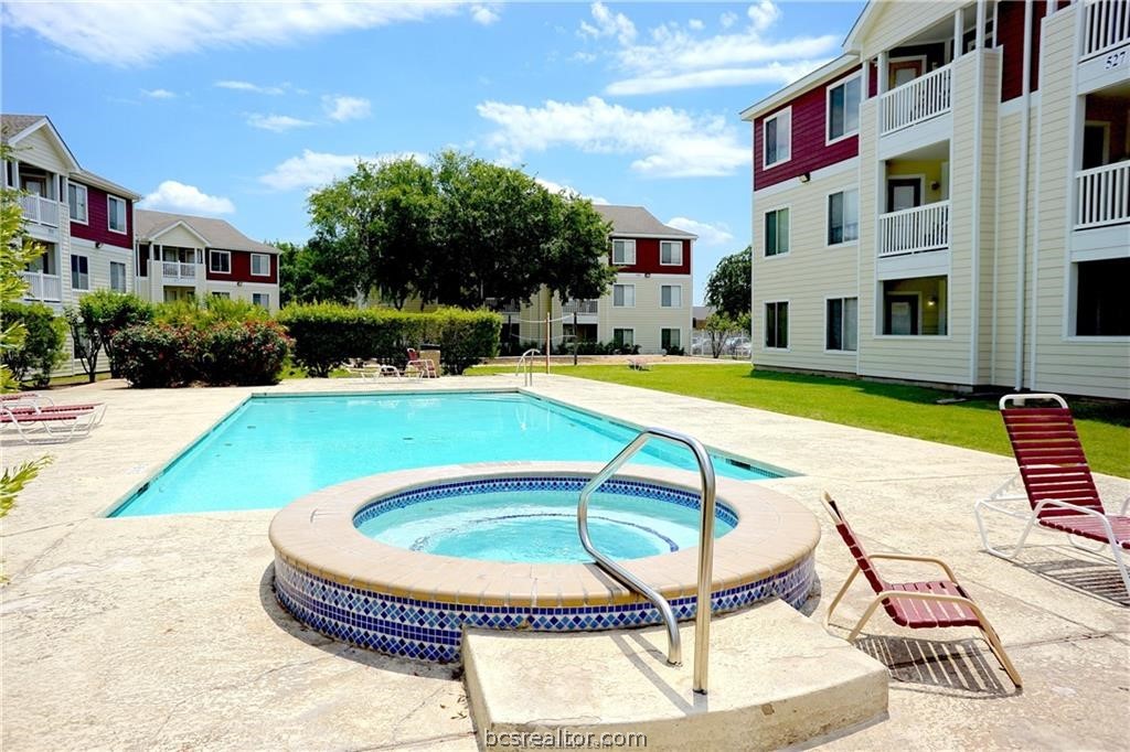 a swimming pool with outdoor seating and yard