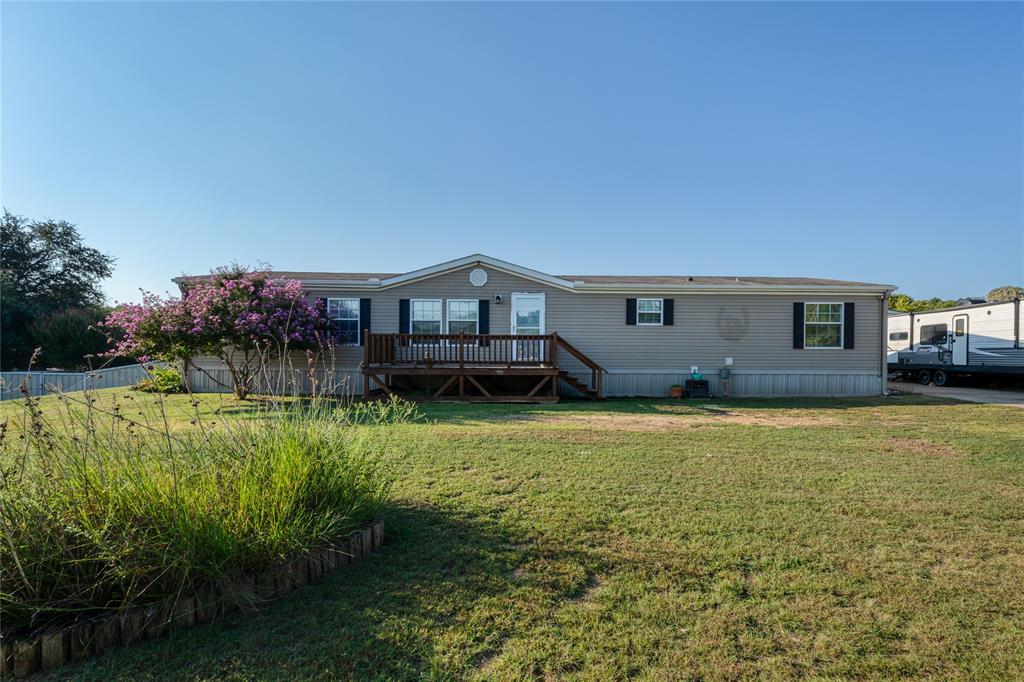 a front view of a house with a garden and deck