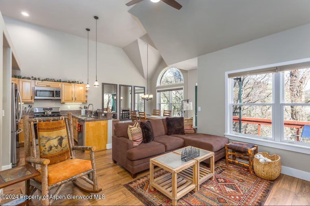 a living room with fireplace furniture and a large window