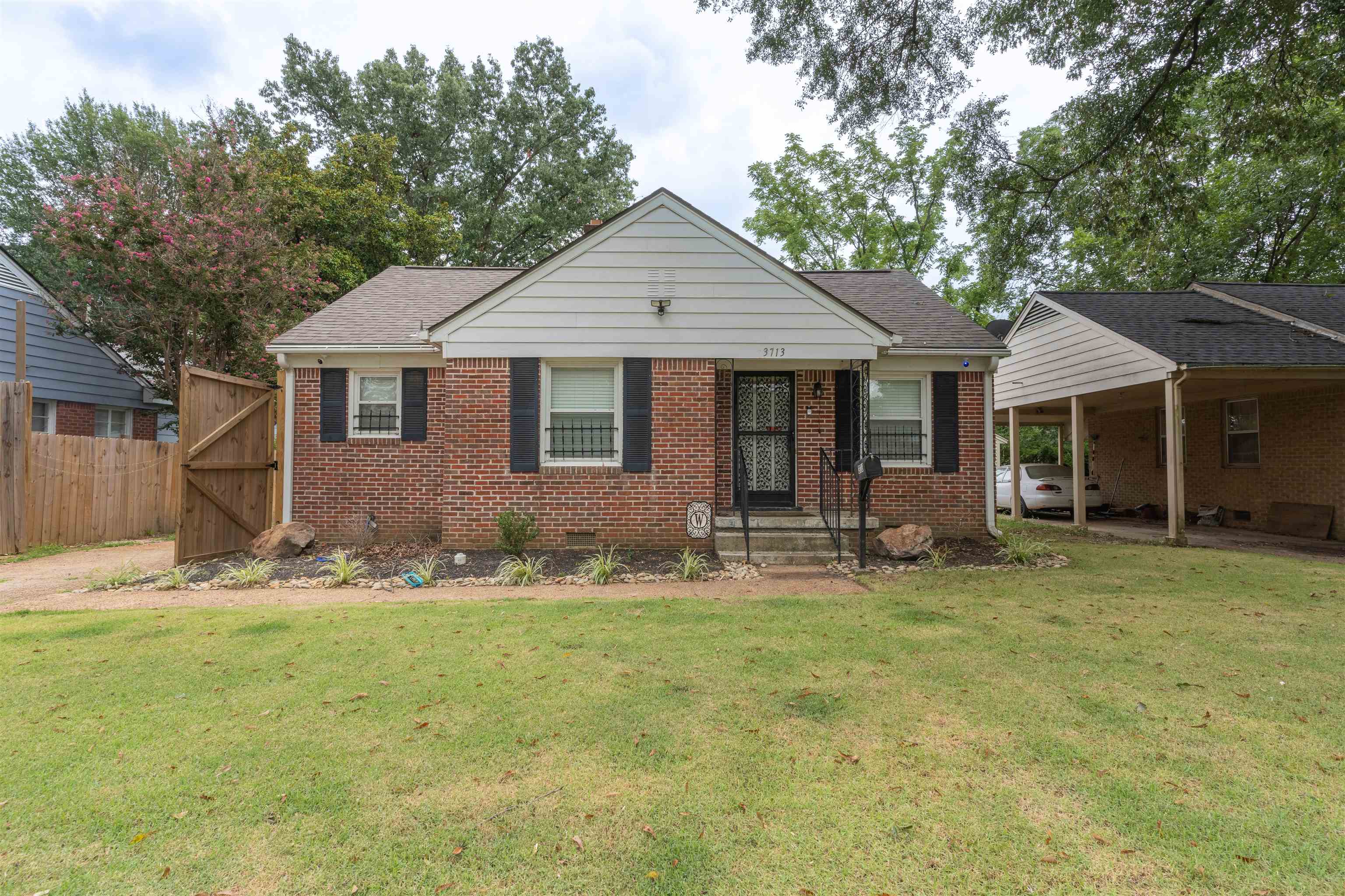 Bungalow-style home featuring a carport and a front yard