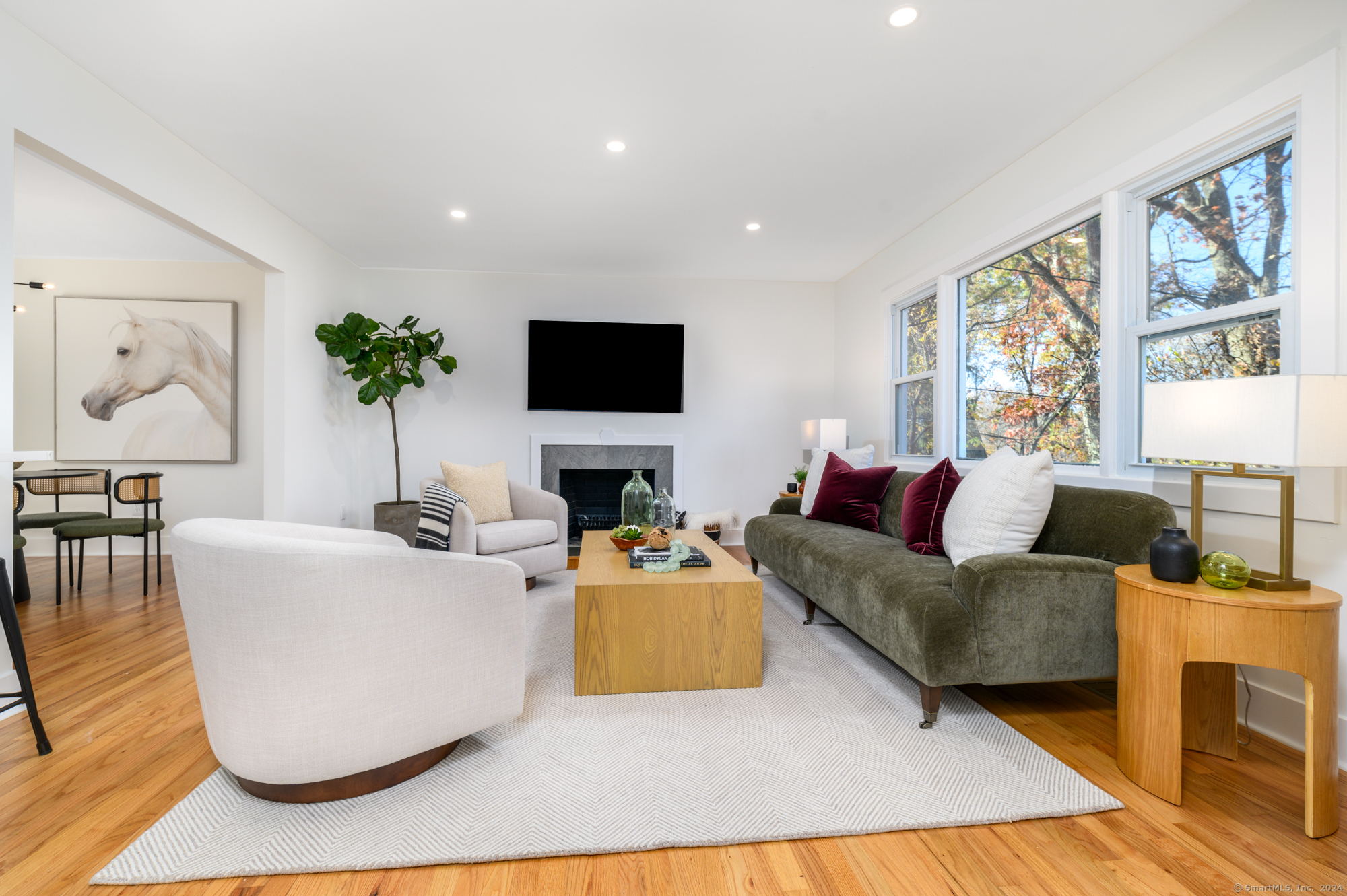 a living room with fireplace furniture and a flat screen tv