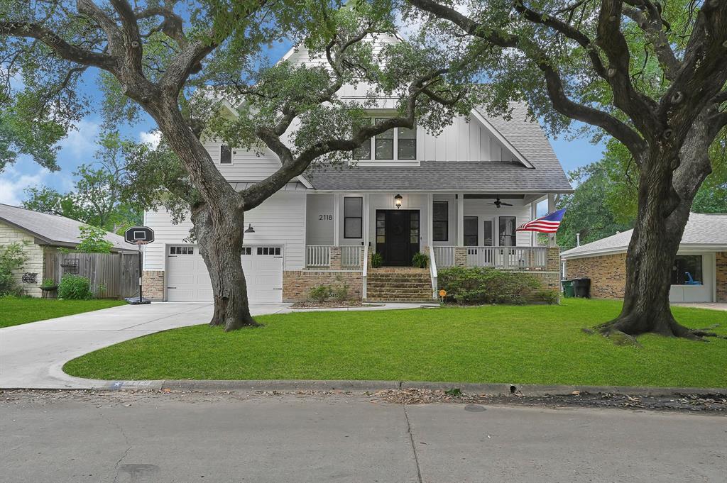 Front of home greets you with two lush Oak Trees offer stunning curb appeal