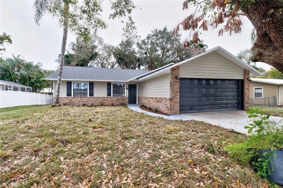 a front view of a house with yard and trees