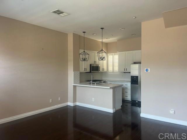 a kitchen with stainless steel appliances a sink stove and refrigerator