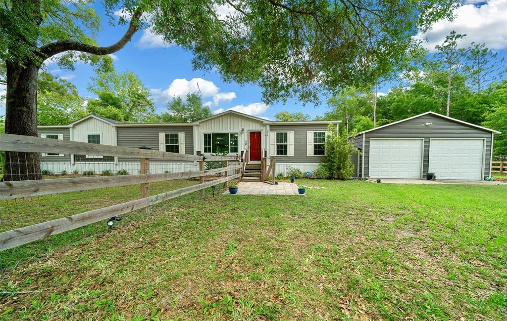 a front view of house with yard and green space