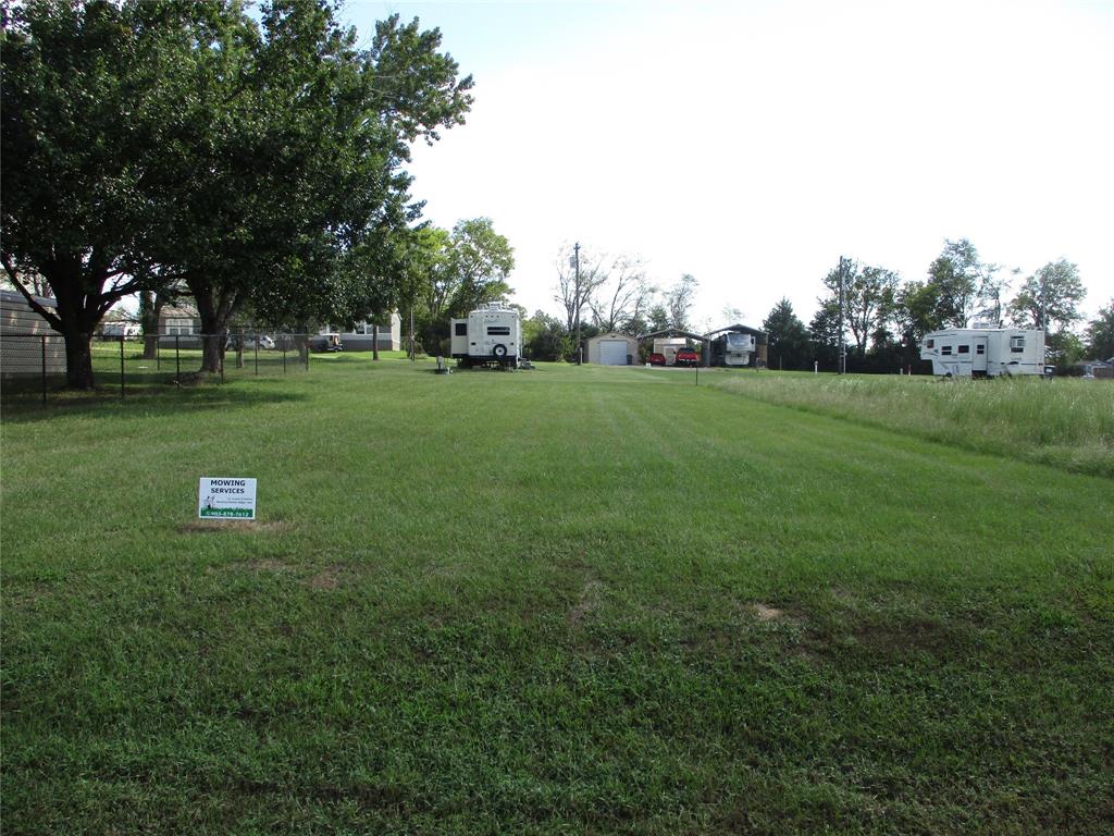 a view of grassy field with trees