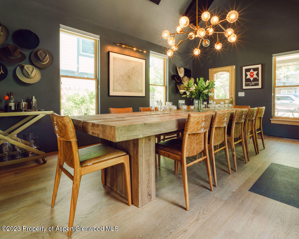 a view of a dining room with furniture and chandelier