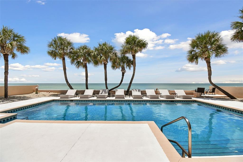 a view of a swimming pool with a table and chair