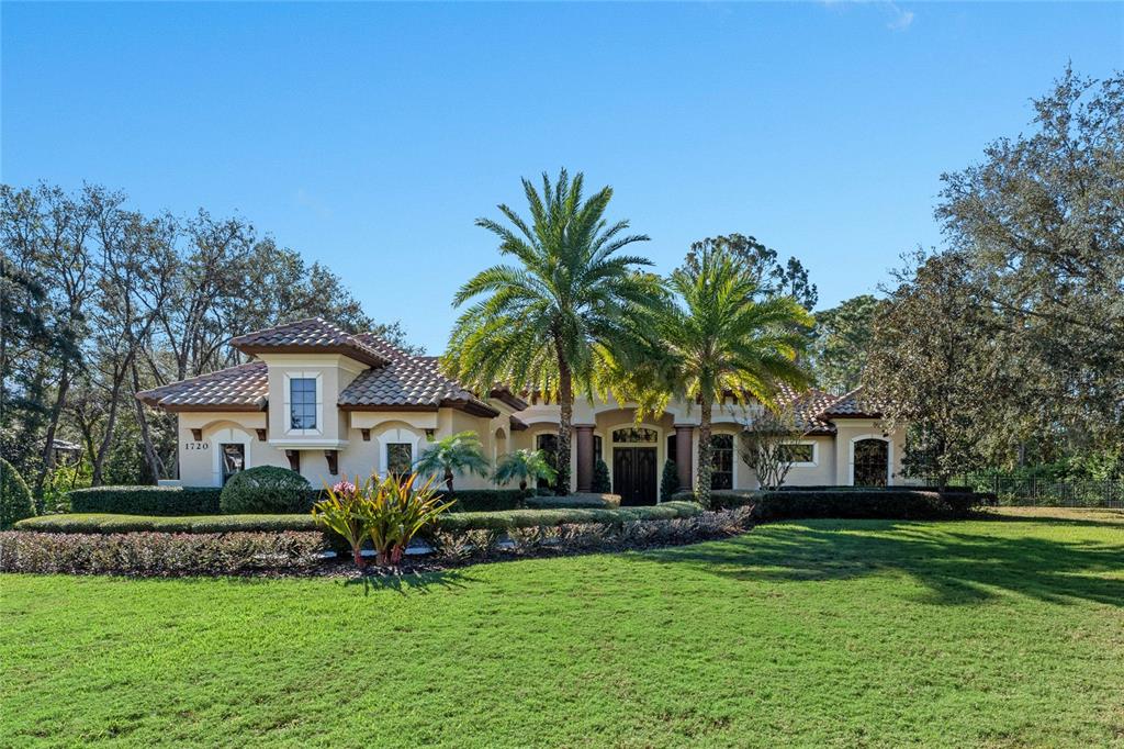 a front view of a house with a garden