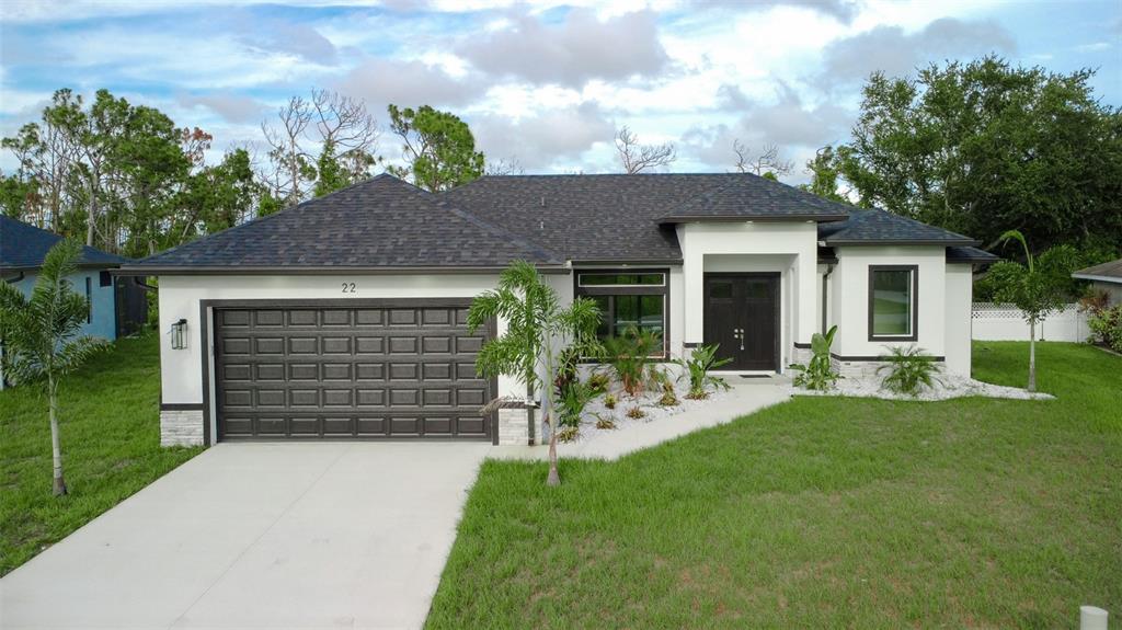 a front view of a house with a garden and yard