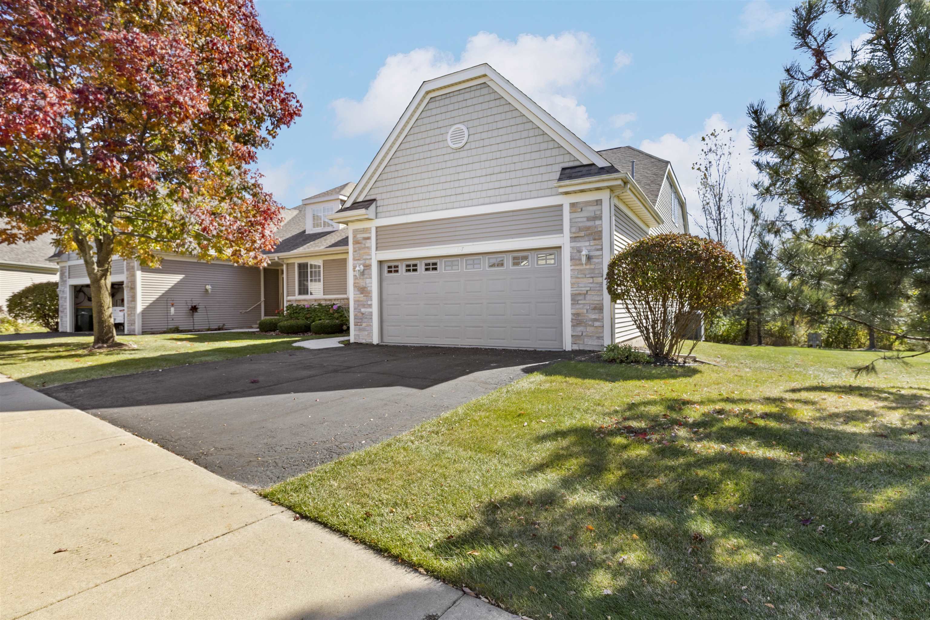 a view of a house with a yard and garage