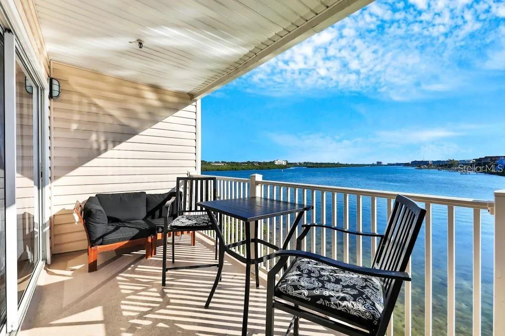 a view of balcony with wooden floor and seating space