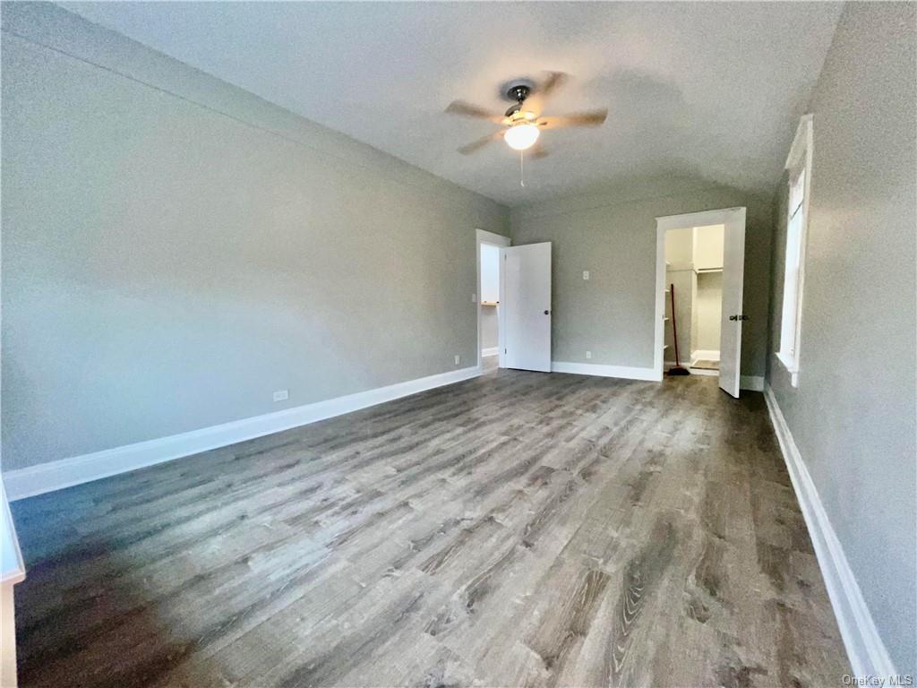 a view of a room with wooden floor and white walls