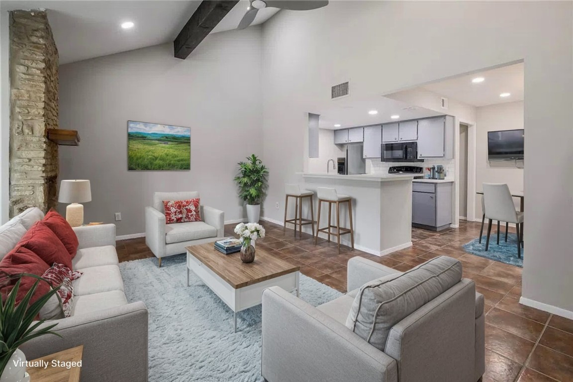 a living room with furniture and kitchen view