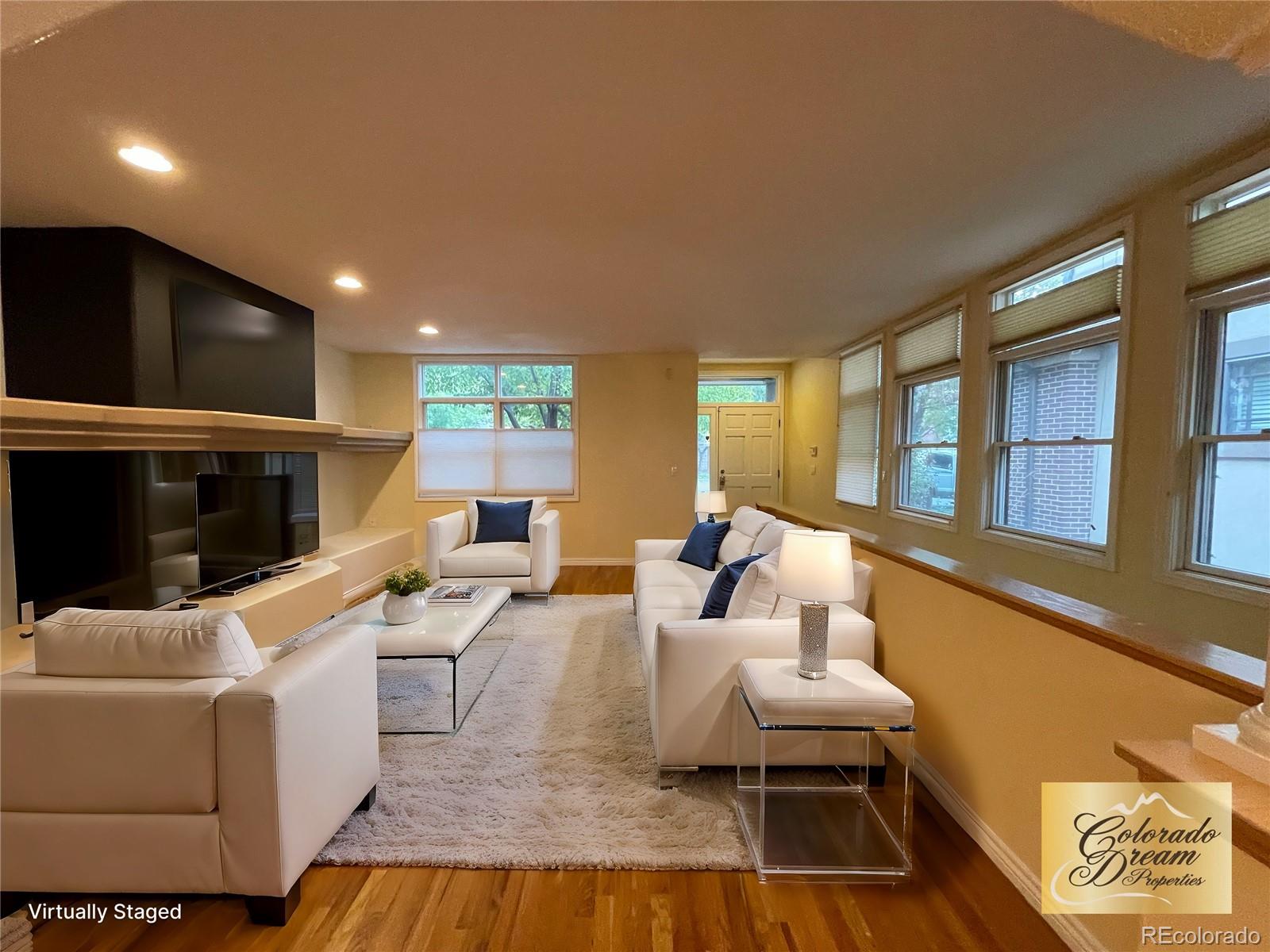 a living room with furniture and a fireplace