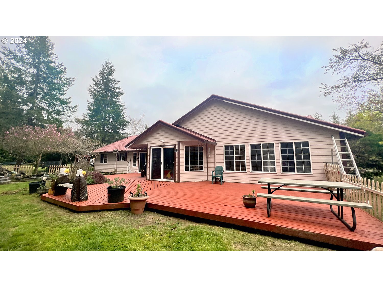 a front view of house with yard and trees