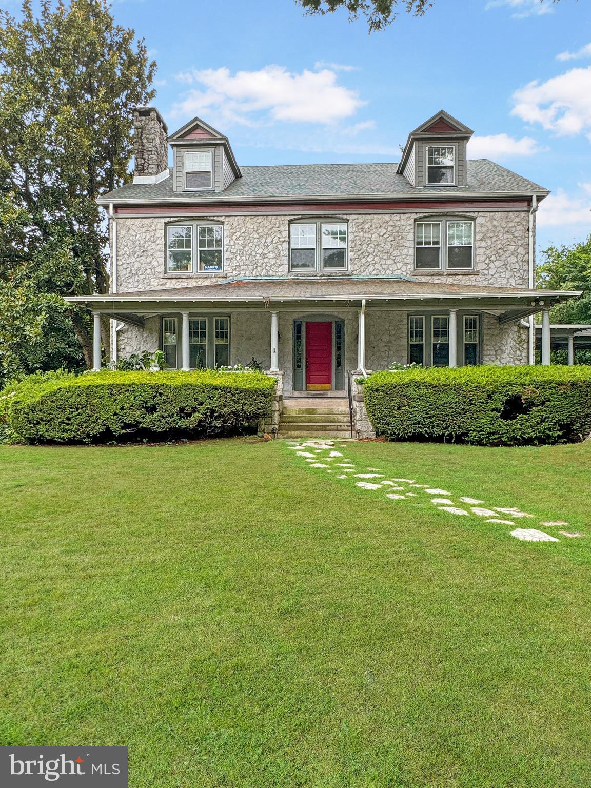 a front view of house with yard and green space