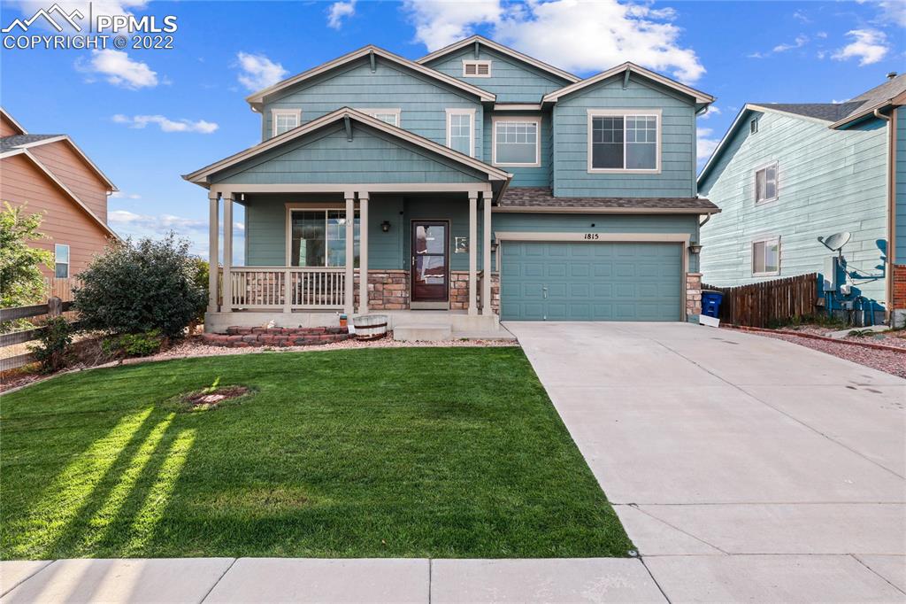 a front view of a house with a yard and patio