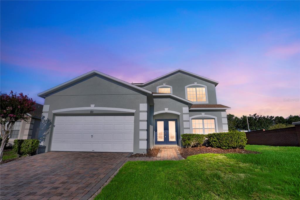 a front view of a house with a yard