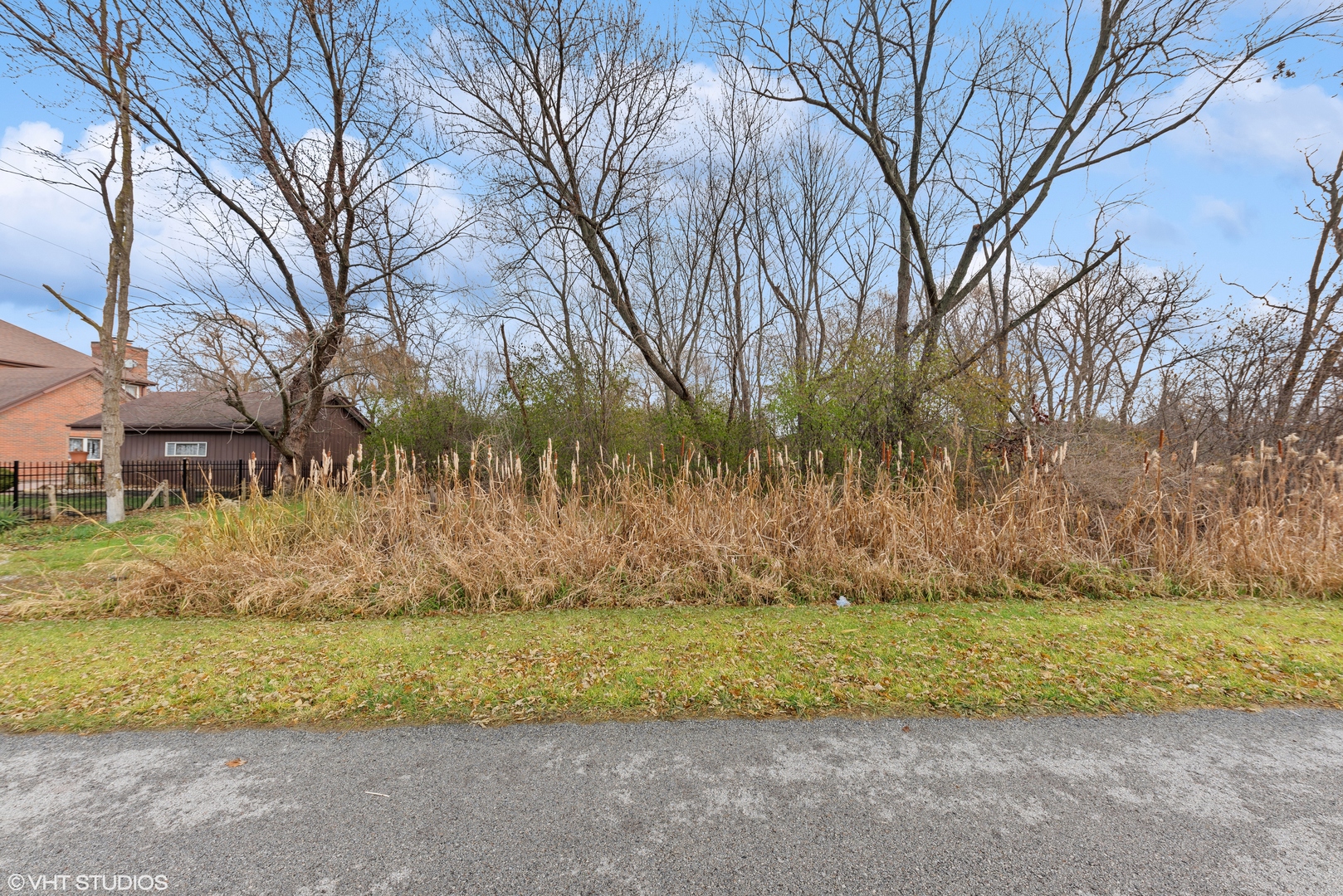 a view of backyard of house with green space