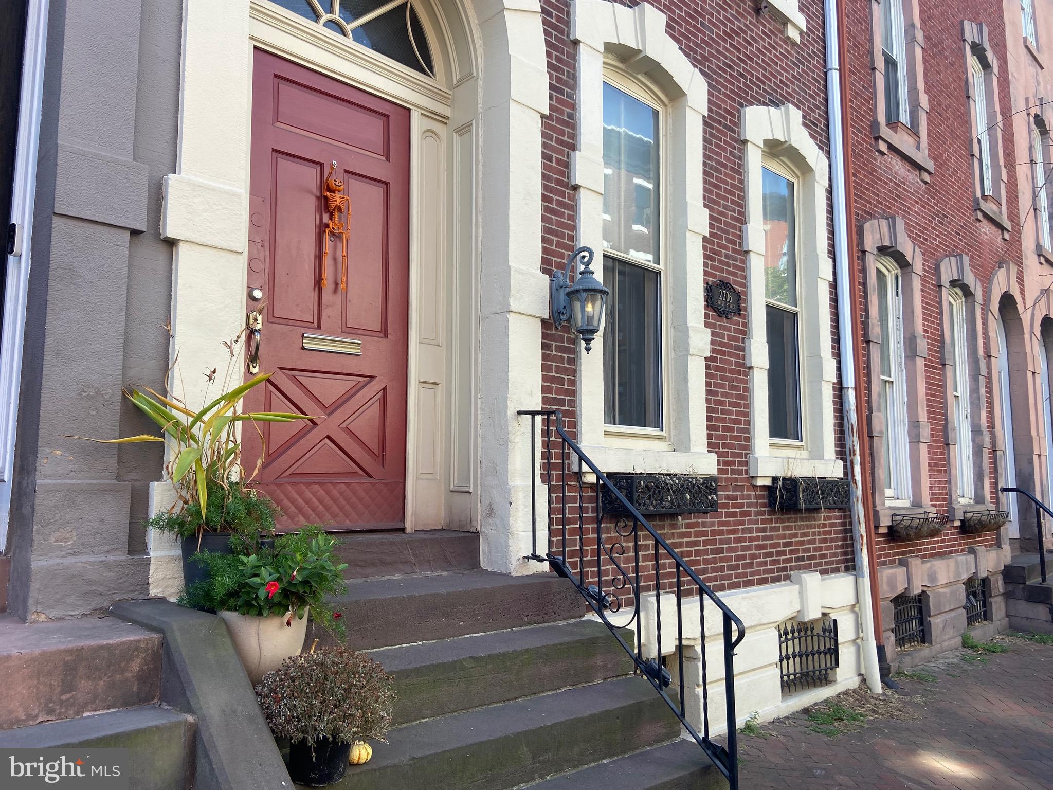 a front view of a building with potted plants