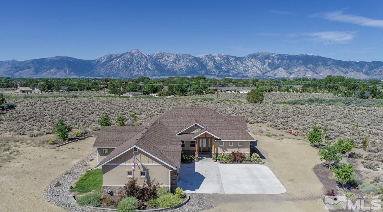 an aerial view of a house and a mountain view