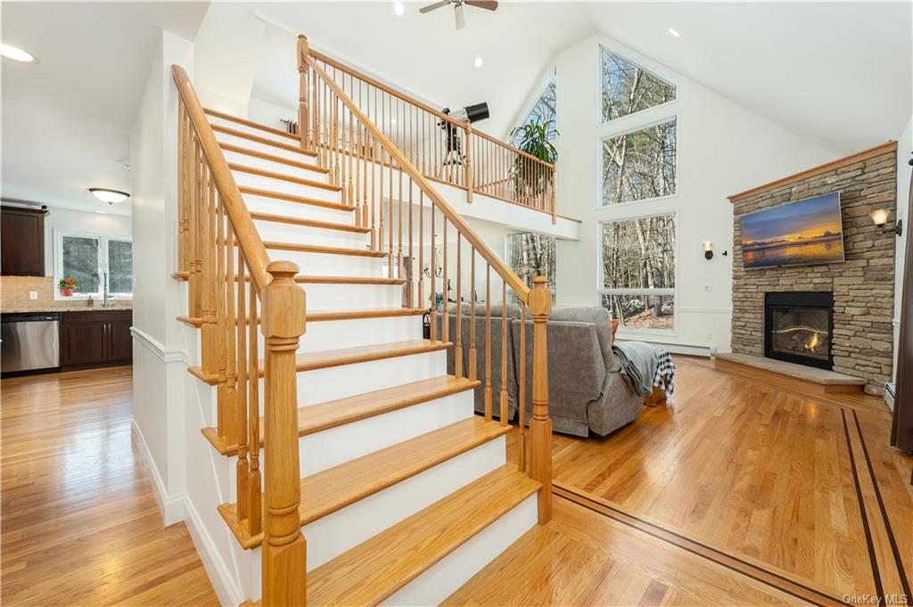 a view of a livingroom with wooden floor and a fireplace