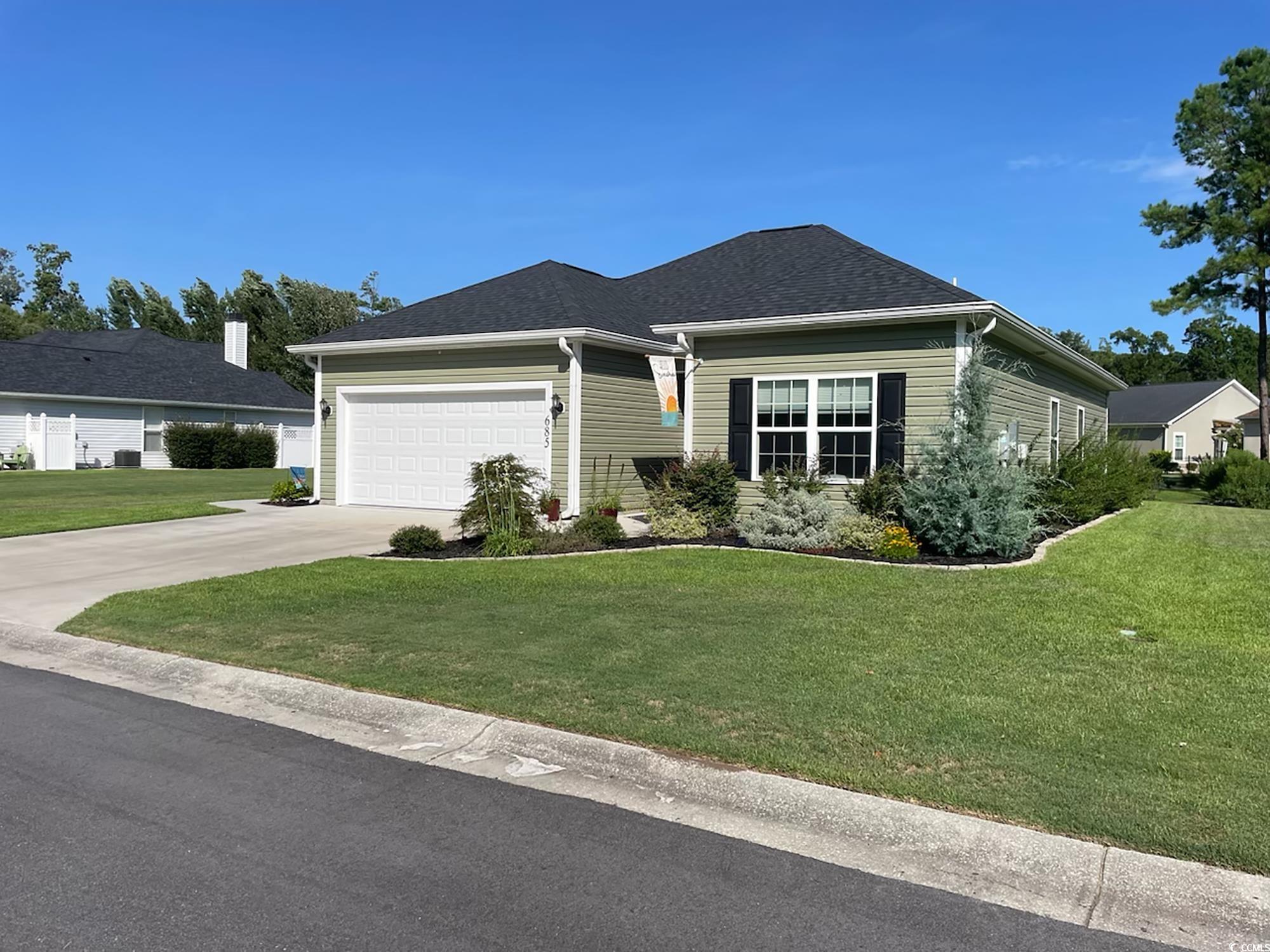 Ranch-style home with a garage and a front yard