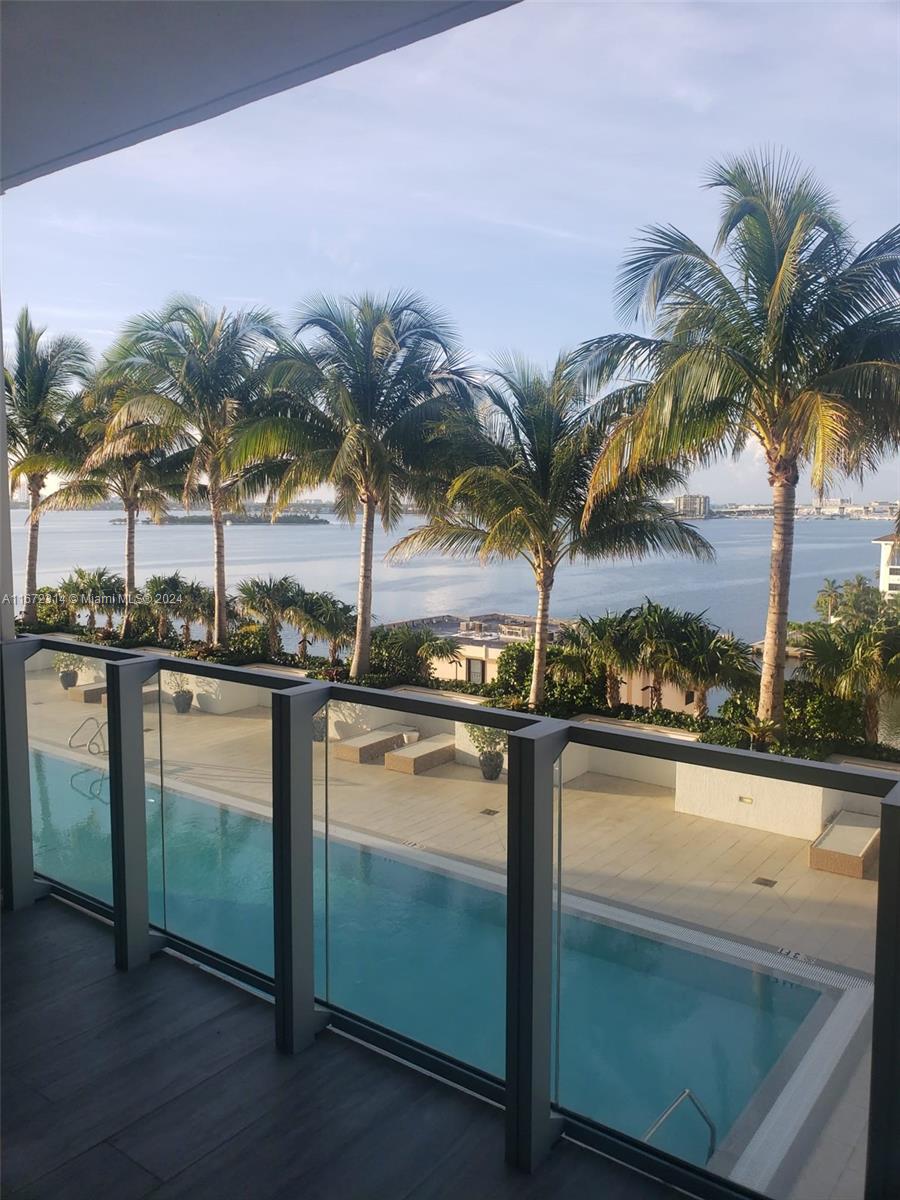 a view of a swimming pool and a lounge chair