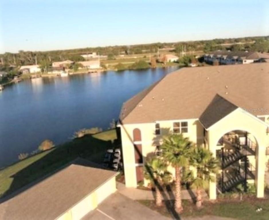 an aerial view of a house with a lake view